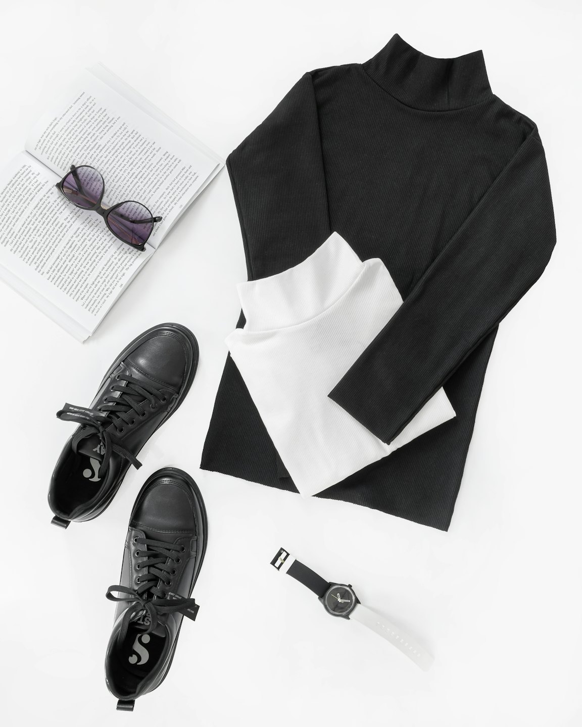 Clothing and accessories arranged neatly on a white surface.